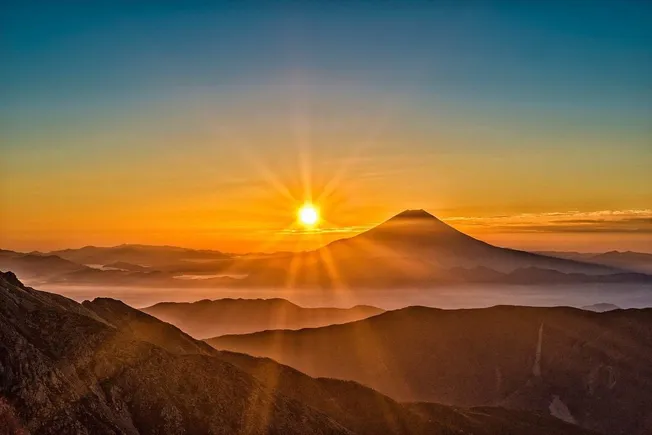 Sunrise over Mount Fuji with vibrant sky and scenic mountain landscape, symbolizing natural beauty and iconic Japan scenery,