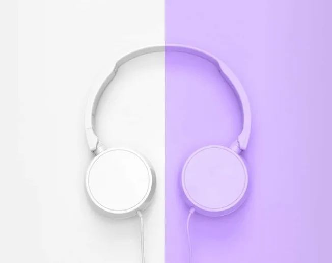 White headphones on split background showcasing modern music technology and digital audio.
