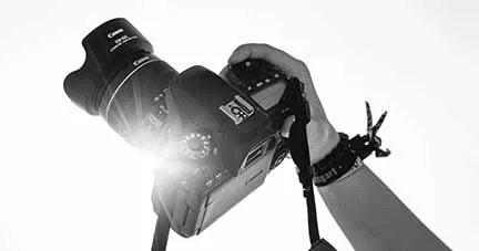 High-quality professional digital camera being operated, ideal for music industry event coverage or media production.