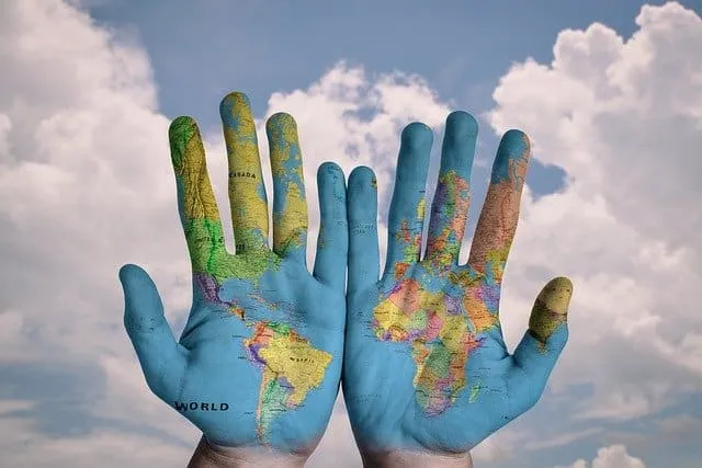 World map painted on hands showing global connection and unity for environmental awareness and sustainability awareness in th