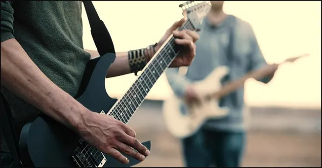 Guitarists performing outdoors during sunset, live music session, vibrant guitar playing, music festival, outdoor concert, mu