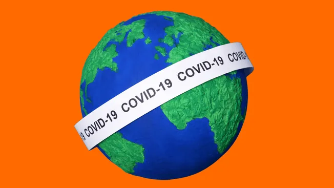 Globe with a COVID-19 awareness ribbon highlighting global pandemic impact on health and economy.