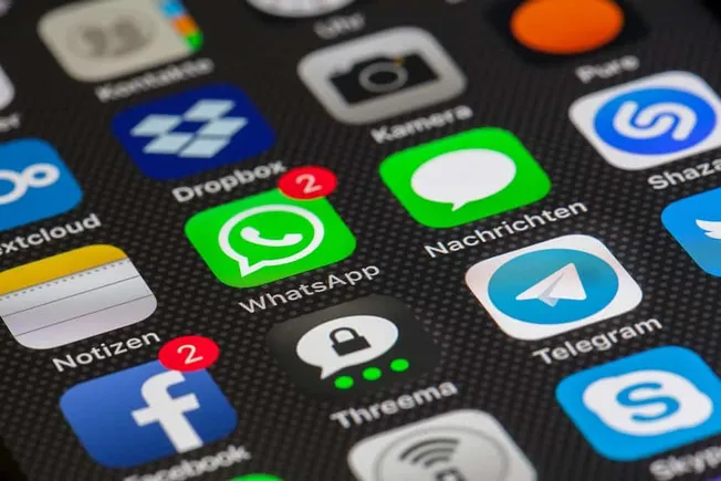 WhatsApp notification icons on a smartphone screen with messaging apps and social media logos.