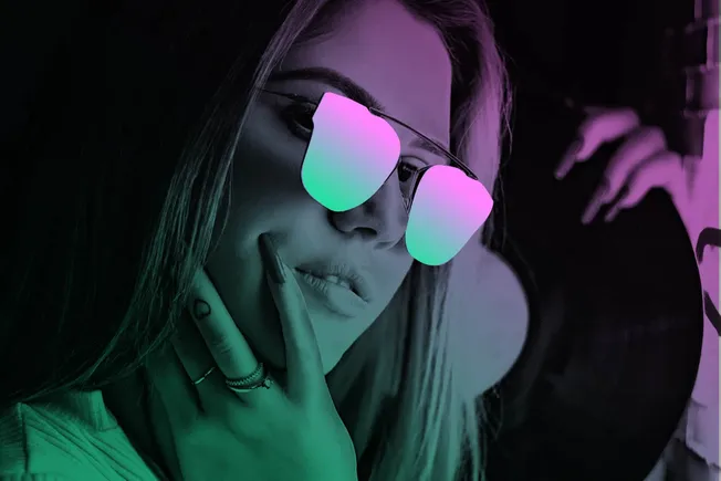 Fashionable woman wearing stylish sunglasses and colorful neon lighting, modern tech accessories, and trendy jewelry, represe