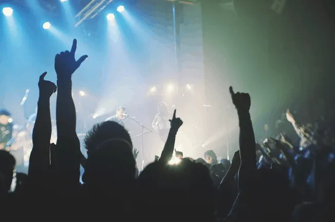 Rock concert with crowd and stage lights, music event, live performance, fans enjoying music, night entertainment, Hypebot mu