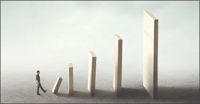 Innovative business growth concept with a person walking towards increasing wooden blocks representing progress and success i