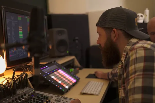 Creative music production with digital audio workstation, electronic music, and beat mixing on computer monitor, keyboard, an