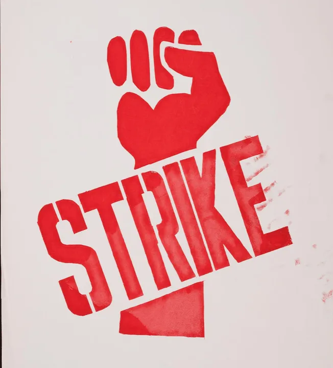Fist with the word "strike" in bold letters, protest symbol, activism, social justice, graphic design, red and white colors.