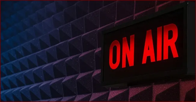 On air radio station sign in a professional recording studio with soundproof foam panels, representing music, broadcasting, a