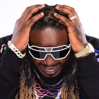 Stylish man wearing futuristic sunglasses and jewelry, adjusting his dreadlocks, expressive face, celebrity vibe, fashion-for