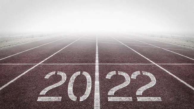End of the running track with the year 2022 and question marks, representing transition to 2023 and new beginnings, symbolic