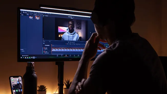 Editing video content on a computer for social media or online platforms, with professional tools and a focused creator in a