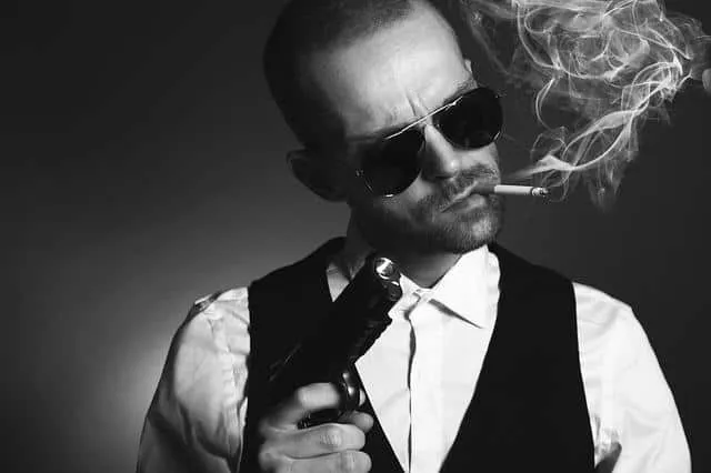 Gunslinger with sunglasses smoking a cigarette, black and white photo, confident rebellious attitude, edgy music scene, cool