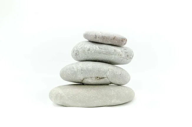 Stacked gray and white smooth stones representing balance and zen relaxation.