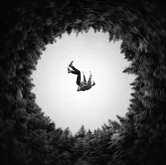 Falling person suspended in mid-air in a dynamic black and white photo, emphasizing motion and surrealism, ideal for creative
