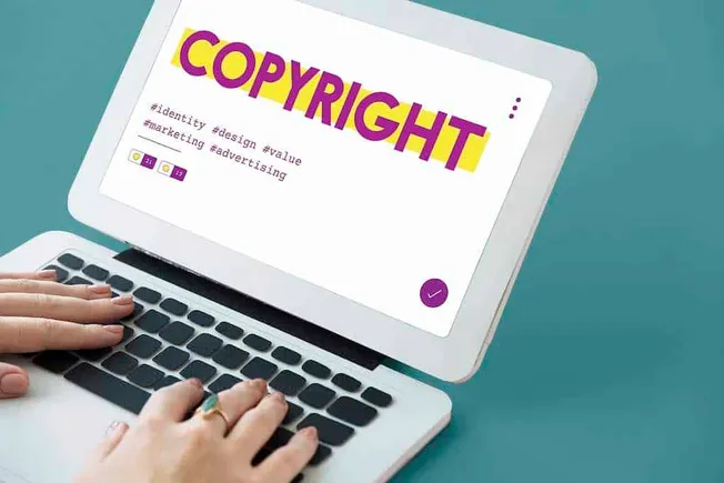 COPYRIGHT symbol on a laptop screen, emphasizing digital rights, intellectual property, and online content protection in the