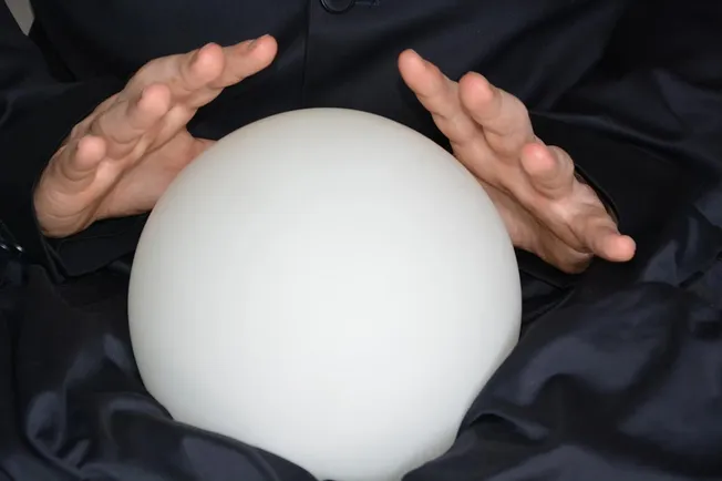 Balloon, magic, or crystal ball in a magician's hands representing illusion or prediction.