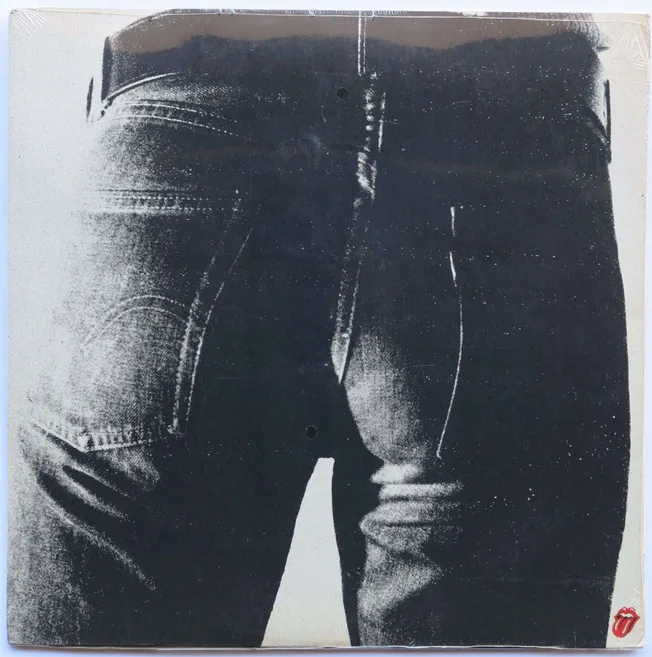 Black and white close-up photo of a person's backside wearing distressed denim jeans, showing the back pockets and waistband,