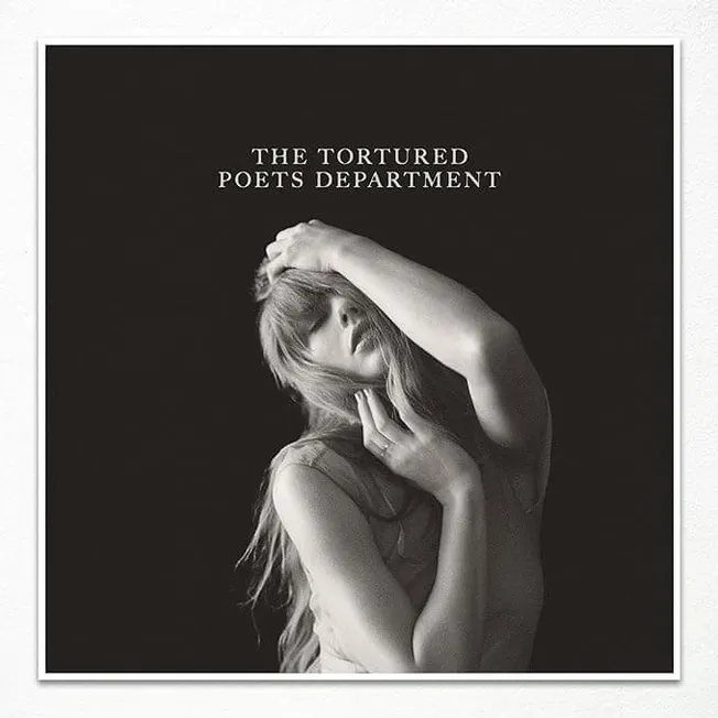 Photograph of a woman with long hair touching her face and head portrayed in black and white, album cover art for The Torture