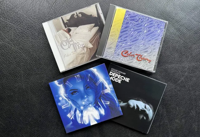 CD albums showcasing music from Depeche Mode and other artists, featuring artistic cover designs and vibrant artwork, placed