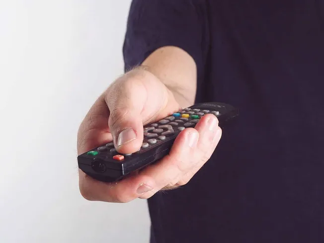 Remote control in hand, TV remote, person holding a television remote, remote control device in hand, for entertainment and m