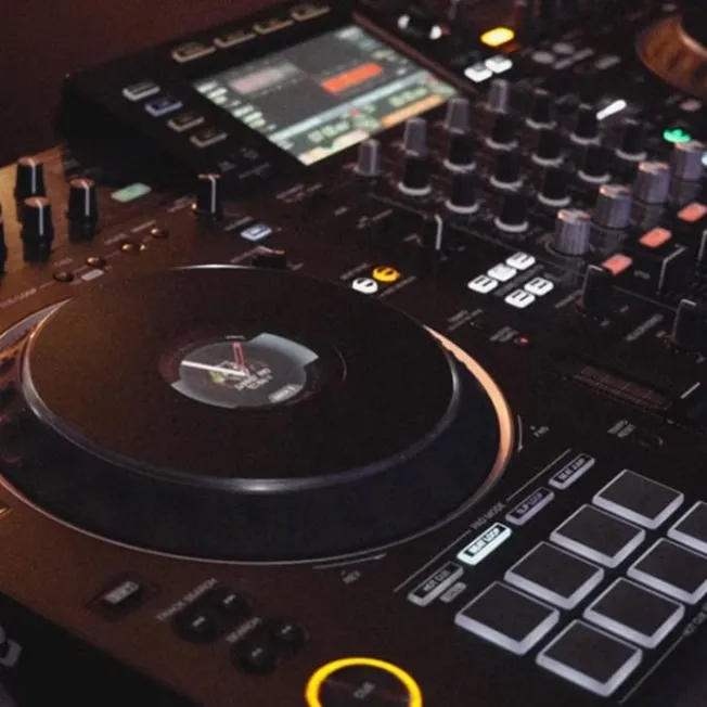 DJ mixing console with turntable and audio controls, professional music equipment for DJ performances, music production, and