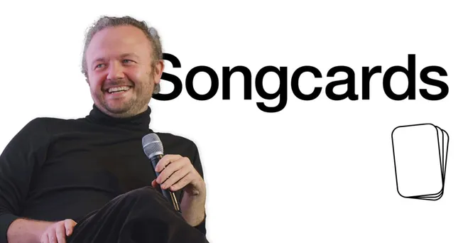 Creative musician holding a microphone at a Songcards event, promoting music streaming and digital music marketing solutions.