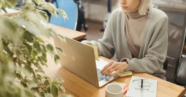 woman checks her email in office.