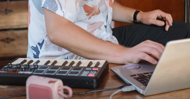 man producing music in at-home studio environment