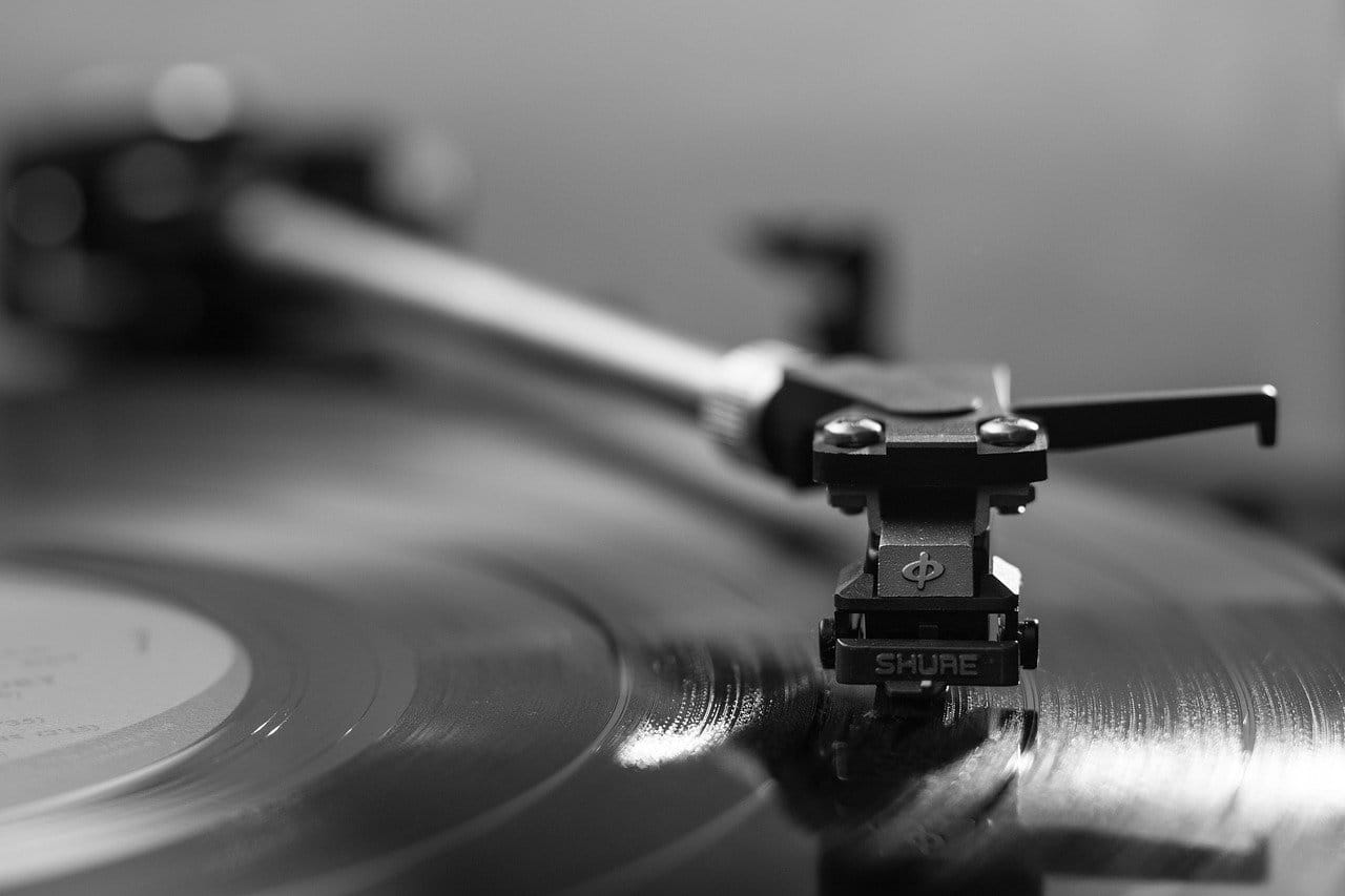 Record player spinning vinyl black and white, turntable vintage music equipment, DJ turntable for audiophiles and music enthusiasts, Hypebot music industry news and insights relevance.