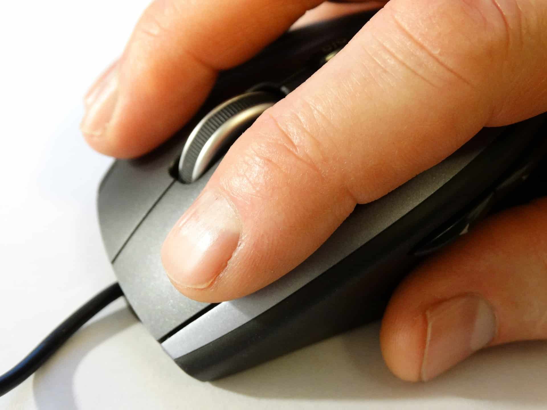 Mouse cursor clicking on a computer mouse, close-up shot, emphasizing digital technology, online marketing, and music streaming trends discussed on Hypebot.