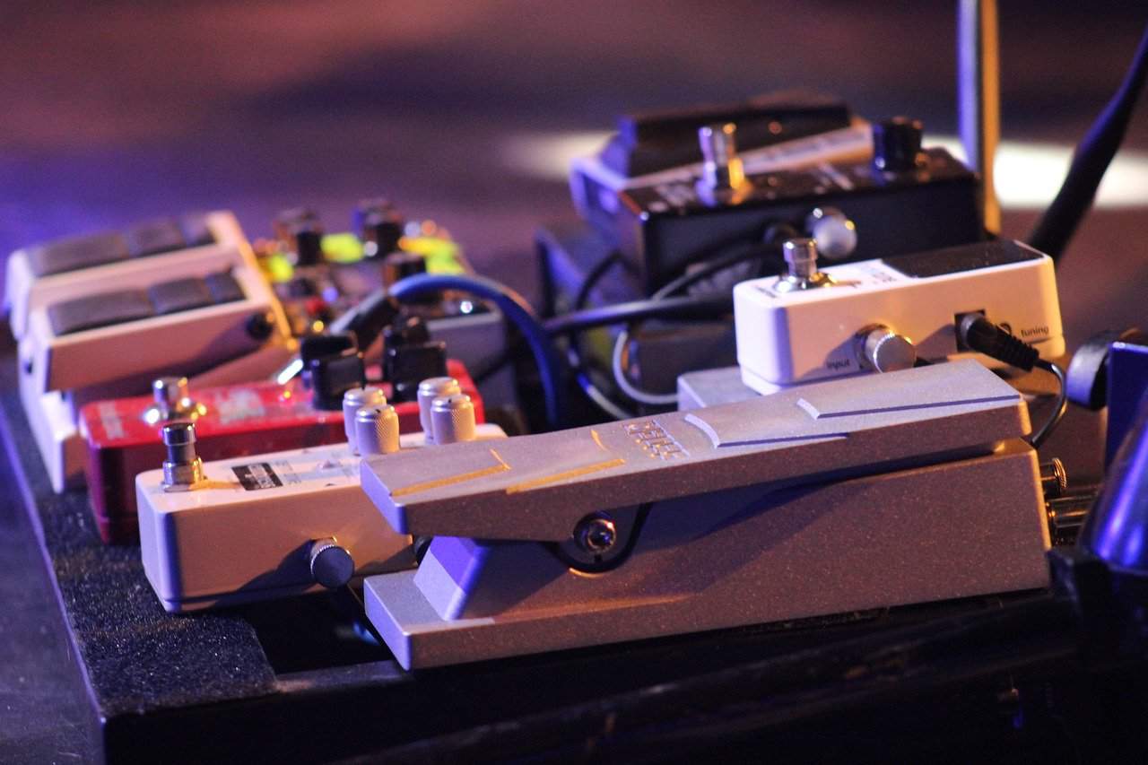 Guitar effect pedals on a pedalboard for live music performances, highlighting guitar tone shaping and effects equipment.