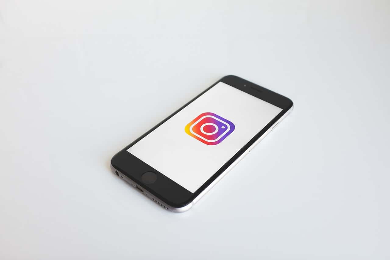 Instagram logo on smartphone screen, social media mobile app, digital marketing, creative media, social networking, technology, social media platform, modern communication, social media marketing, mobile app development, digital branding, visual content, social engagement, online interactions, social influencer, app icon, smartphone technology.