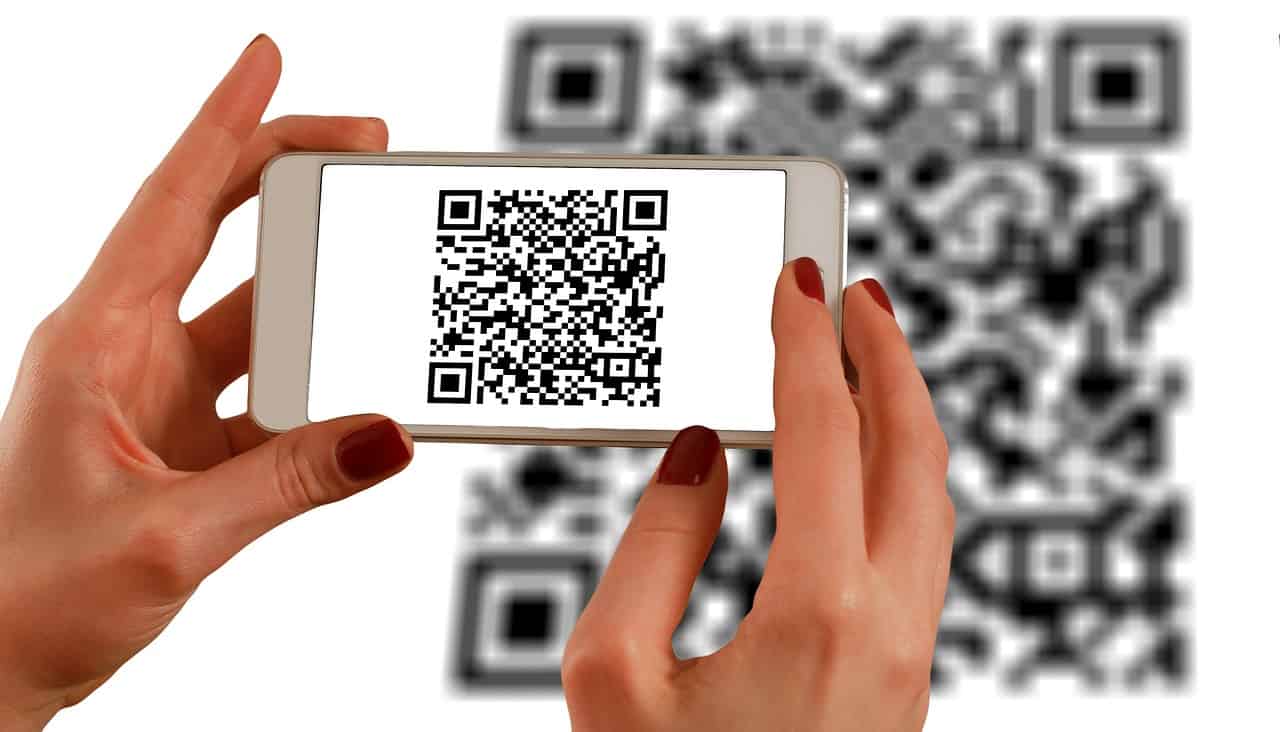 QR code scan on smartphone for digital content or music link.