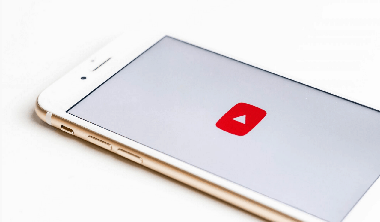 Mobile phone with YouTube app open, showcasing video content, representing digital media, online streaming, and content creation.