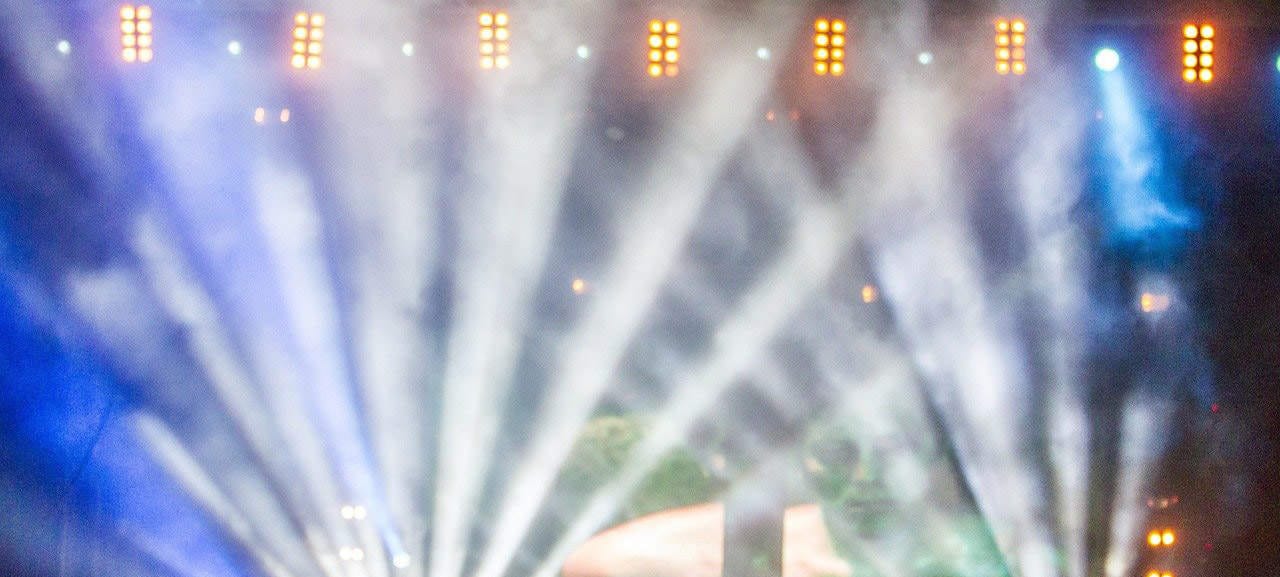 Laser light beams and stage lighting at a live music concert or festival.