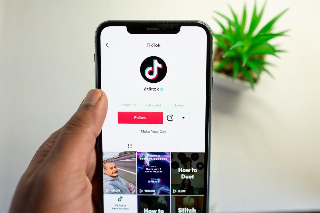TikTok app displayed on smartphone screen, showcasing trending short-form videos and content creation tools.