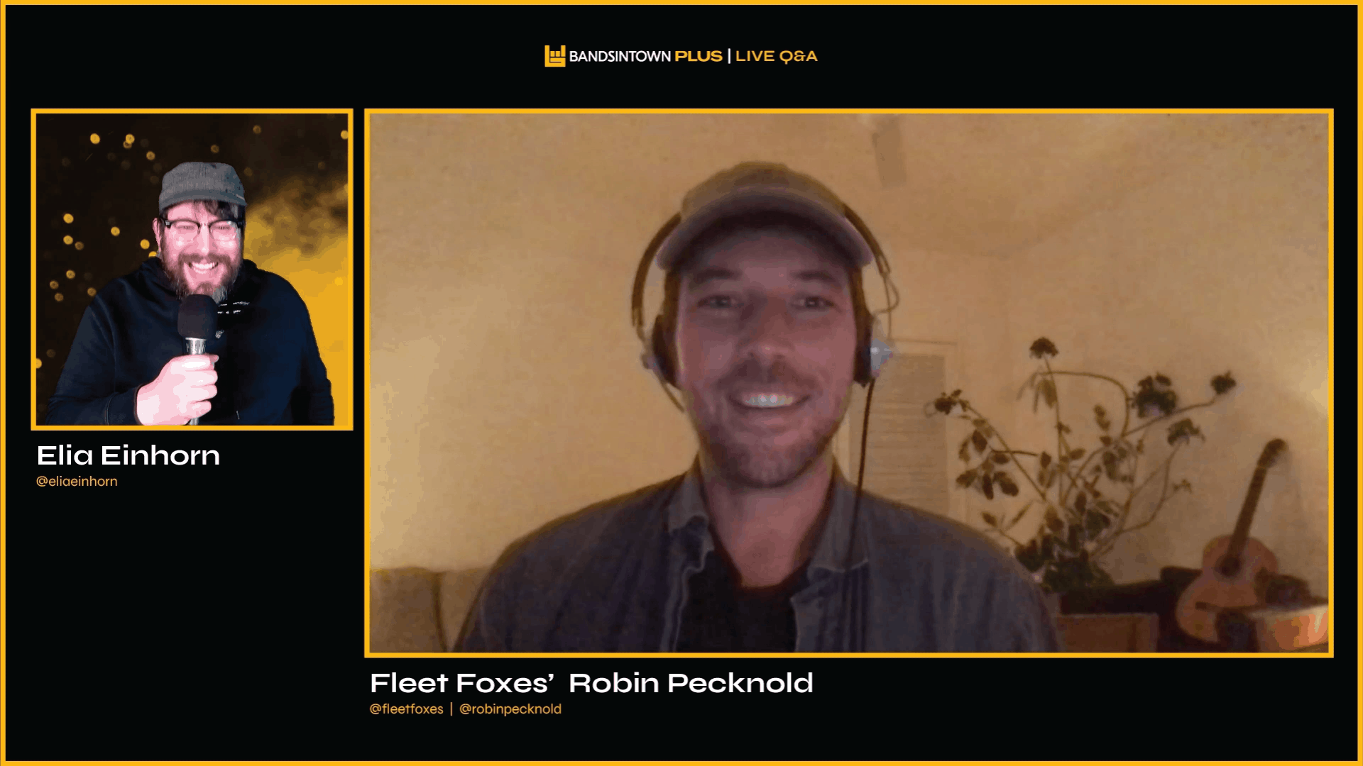 Broadcaster and musician Robin Pecknold from Fleet Foxes speaking in a live online event with Elia Einhorn, in a home setting with a guitar and houseplant in the background.