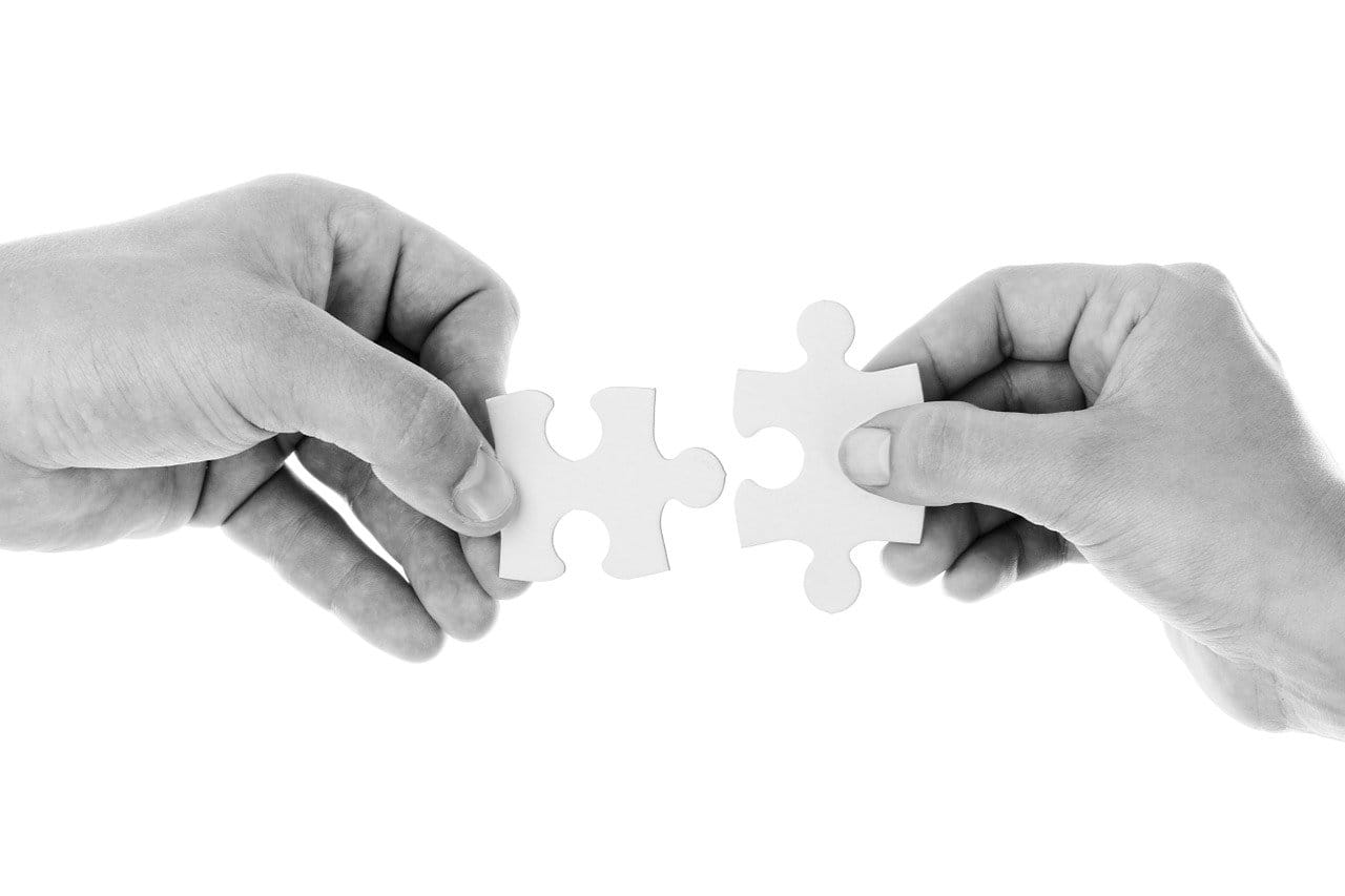 Connecting music industry insights with puzzle piece hands, representing collaboration and innovation in digital media and music marketing strategies.