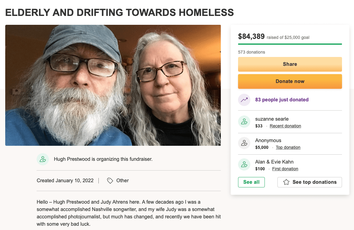 Elderly couple fundraising for homelessness, charity donation, senior citizens support, compassionate community needs, elderly and homeless relief.