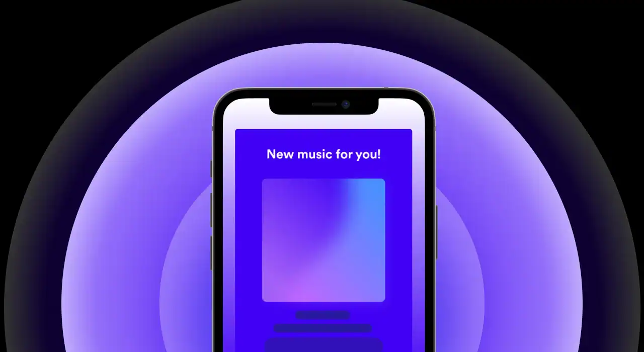 Mobile smartphone displaying a music app with the text "New music for you!" on a vibrant purple and black background.
