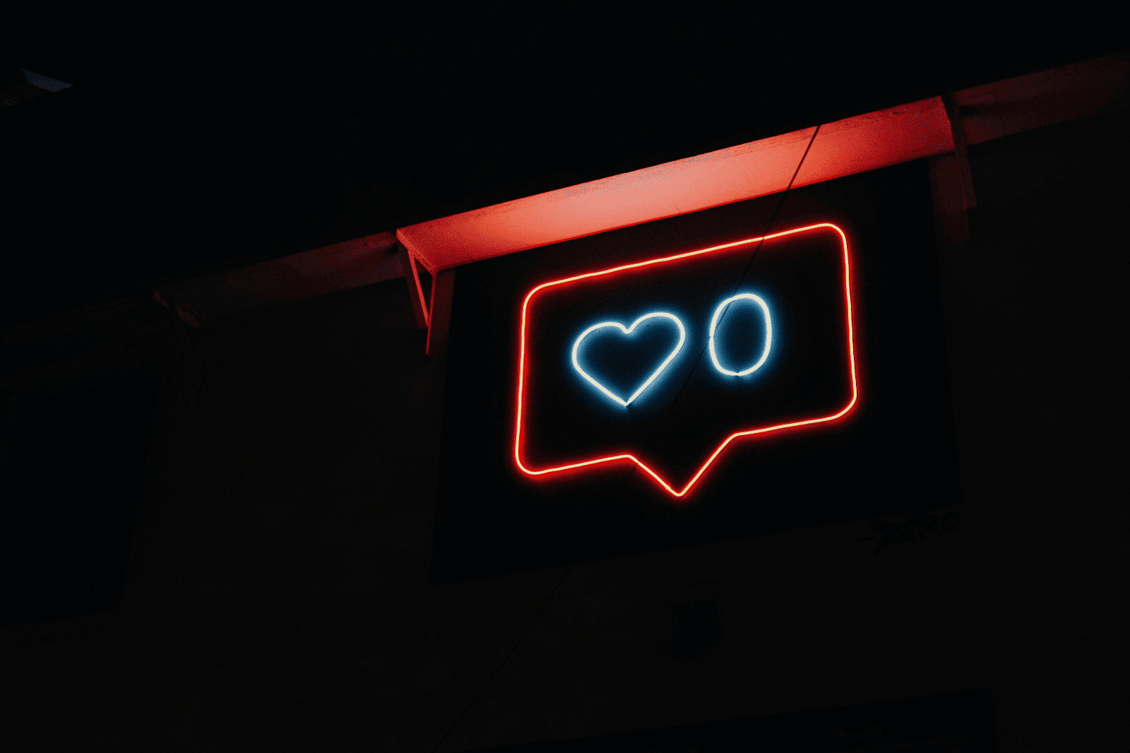 Neon social media notification sign with heart and comment icons, dark background, trendy digital art for social media engagement, modern neon decor, social media love icon, nightlife aesthetic, digital marketing visual.