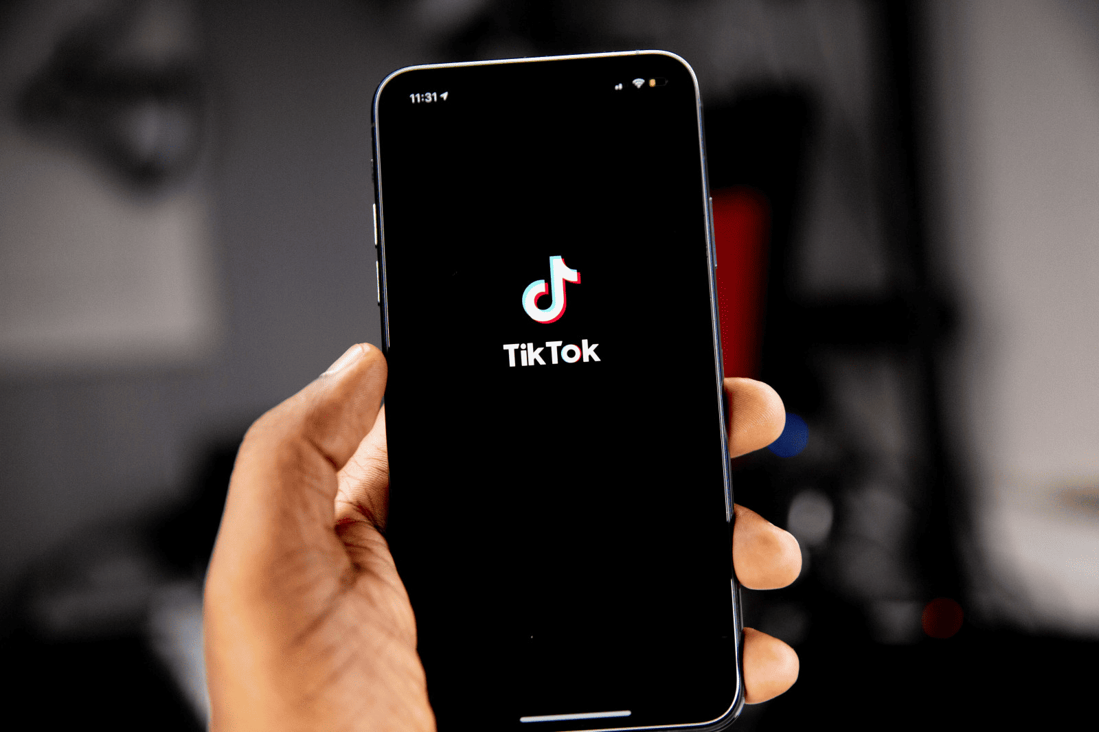 TikTok logo displayed on smartphone screen, showcasing social media, video content, and digital marketing trends., Popular TikTok app on mobile device emphasizing social media marketing and short-form video content., Hand holding smartphone with TikTok logo on screen, highlighting social media, influencer marketing, and digital trends in the entertainment industry.