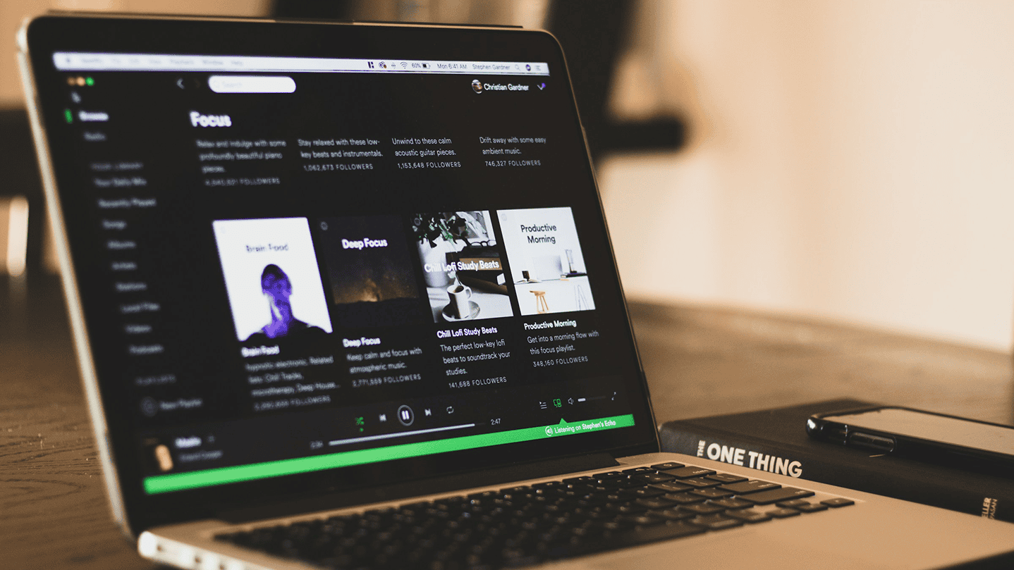 Music streaming Spotify on laptop screen, music playlist, digital music service, online music listening, music app interface, focus playlist, chill vibe, music discovery platform, music lover, digital entertainment relevance.
