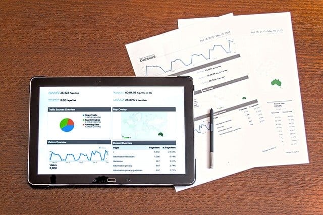 Broad digital analytics dashboard on tablet displaying website traffic and user engagement metrics for marketing analysis.