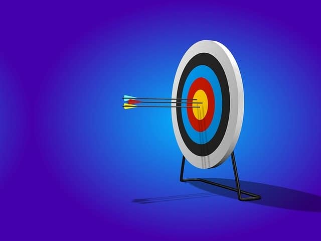 Aiming at a target with three arrows hitting the bullseye, symbolizing precision and goal achievement in music marketing and promotional strategies for the music industry.