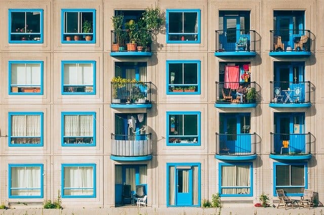 Modern apartment building with colorful balconies and windows, showcasing urban living aesthetics, home decor, and architectural design elements.