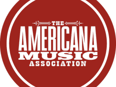 A vibrant red circular logo for the Americana Music Association featuring bold text.