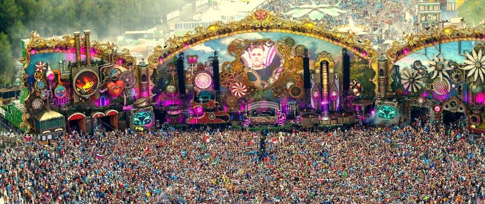 Carnival music festival stage with vibrant lights and large crowd, showcasing electronic dance music, festival entertainment, and live DJ performances, ideal for music event promotion.