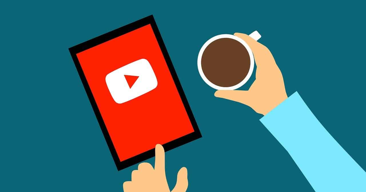 Youthful hand pointing at YouTube app on smartphone with coffee cup, digital media, music streaming, content creation, online video platform, Hypebot image.